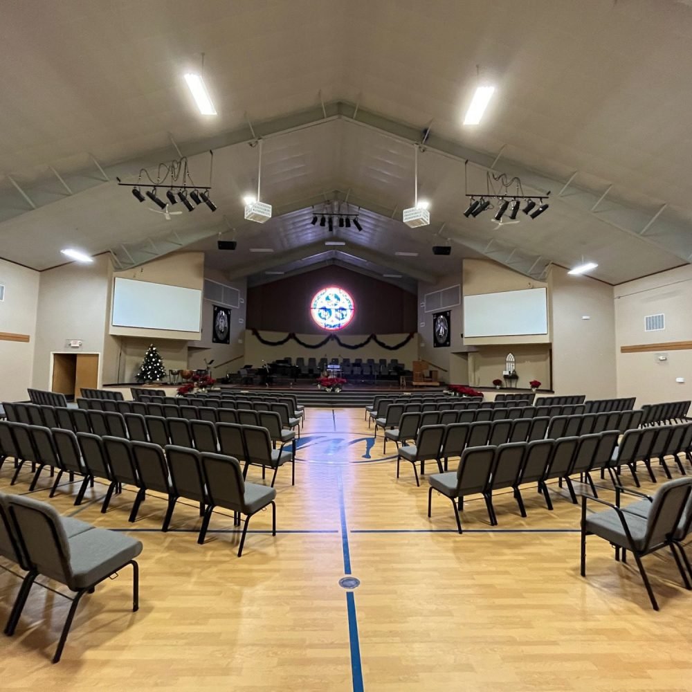 Interior gymnasium view of Memorial Baptist Church with chairs in a row