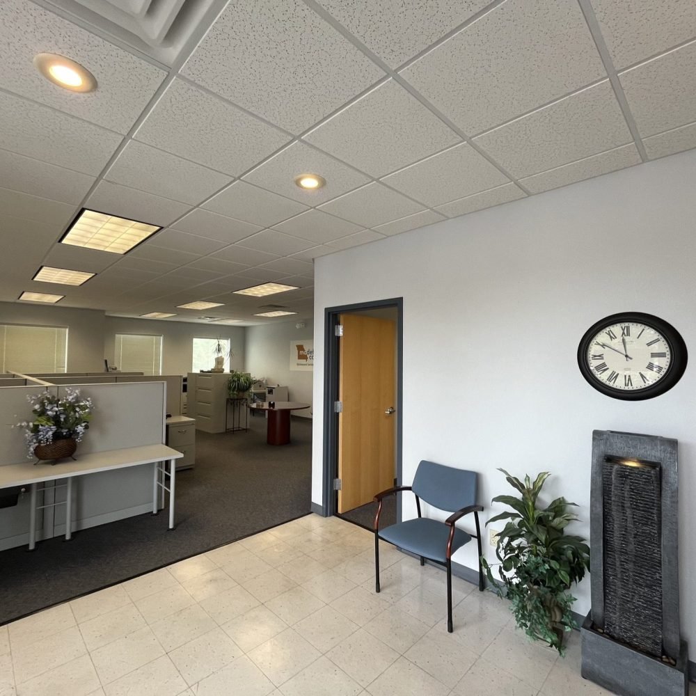 Interior lobby area of American Building with chair clock and desks
